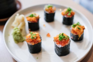 Salmon eggs or Ikura in Japanese style sushi fresh from raw salmond fish in the restaurant.