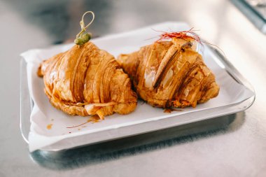 Freshly baked croissants on the tray, brunch at coffee shop.