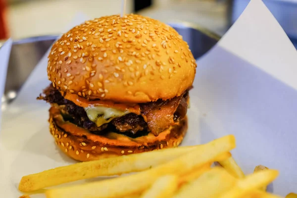 Beef burger with french fries in the restaurant.