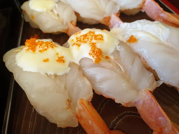 Japanese food in set different types of sushi with seaweed salad and gari (ginger) is a healthy food at the upper right of the serving board in japan restaurant