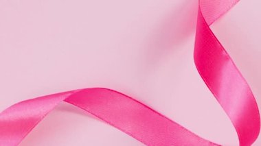 Renkli arka planda pembe kurdele. Meme Kanseri Farkındalığı Ayı sembolü. Kadınların sağlık hizmetleri kavramı.