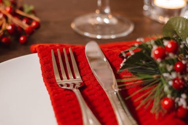 Noel sofrası. Tabak ve çatal bıçak takımı peçeteye. Şenlik yemeğine hazırlanıyorum. Noel arifesinde mumlar yanıyor..