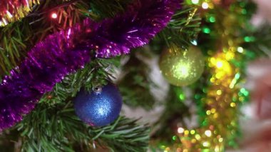 Kadın Noel ağacından süslemeleri kaldırıyor. Yeni yıl kutlamalarının sonu. Kadın elleri Noel toplarını tutar.