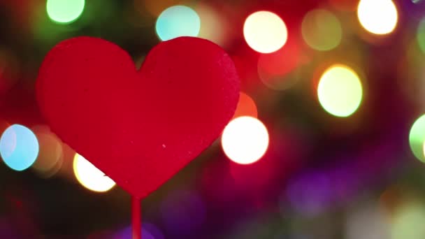 Decoración para San Valentín. El corazón rojo gira sobre el fondo de las luces. La celebración del día de los enamorados. — Vídeos de Stock