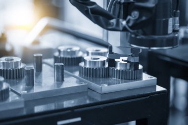 Metal parçalı robotik sistem tarafından yapılan yüksek teknoloji malzeme işleme süreci. Otomatik pnömatik robotik kol üretim hattındaki mekanik parçaları seçer. 