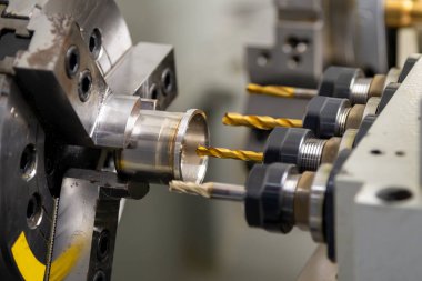 The  CNC multi-tasking machine swiss type  hole drilling the metal cylindrical shape parts. The hi-technology metal working processing by CNC machine .