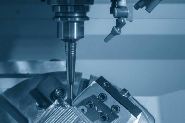 The 5-axis CNC milling machine  cutting the metal mold part. The hi-technology injection mold part manufacturing process by 5-axis machining center.
