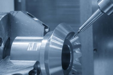 The multi-tasking CNC machine  cutting the differential gear part. The hi-technology automotive part manufacturing process by CNC lathe.