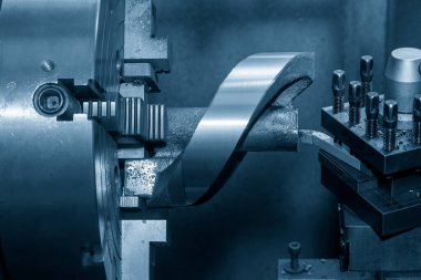 The lathe machine rough cutting the die casting part  by lathe tools. The metalworking process by turning machine.