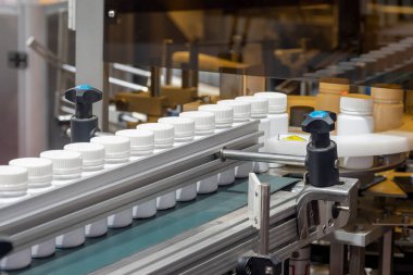 The drug filling process in the plastic bottle. The medical manufacturing process in medical factory.
