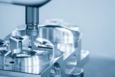 The  CMM machine measuring the aluminum  parts . The quality control of automotive parts with multi axis CMM machine.