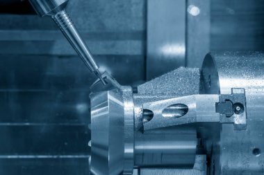 The multi-tasking CNC machine  cutting the differential gear part. The hi-technology automotive part manufacturing process by CNC lathe.