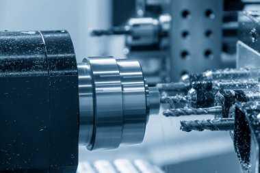 The multi-tasking CNC lathe machine swiss type tapping the brass shaft parts. The high technology metal working with CNC turning machine.