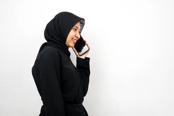 美しい若いアジアのイスラム教徒の女性は自信を持って笑顔と陽気に誰かを呼び出します 空のスペースに直面して 白い背景に隔離されました 広告コンセプト — ストック写真