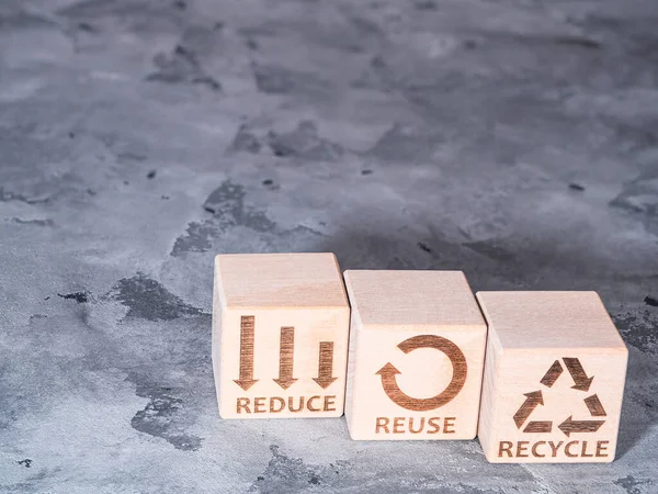 Renewable resource and environmental conservation concept as REDUCE, REUSE and RECYCLE symbols