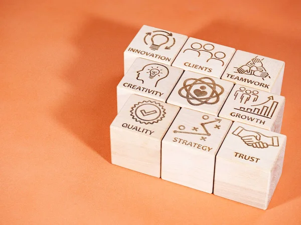 Symbols on wooden cubes as corporate values concept