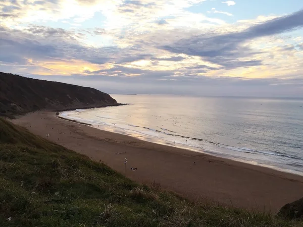 beautiful sunset in basque country beach , north of Spain. Last bathers of day.