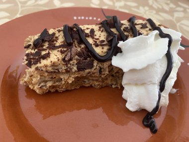 Homemade cake. Cake with cream, pudding, butterscotch and chocolate.