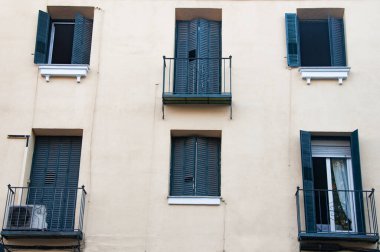 Vintage windows and small balconies on facade of old building in the centre of Madrid. Spain. 2022
