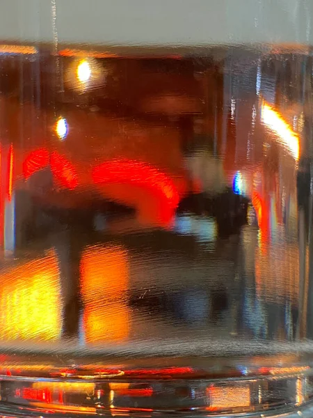 Blurred abstract waitress or person on restaurant or pub. Glass defocused lightening background . Beautiful bright interior.Blurred basic background