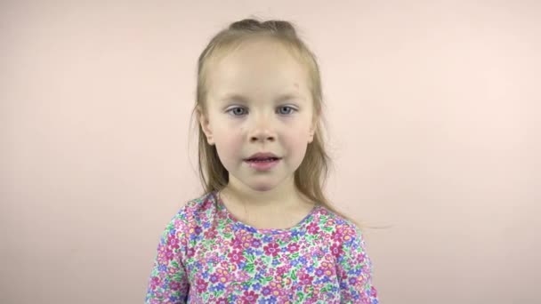 Happy little child girl looking at the camera and grimacing, — Video Stock