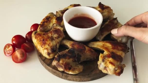 Woman Hand Takes Grilled Chicken Wing Dips Tomato Sauce — Stock Video