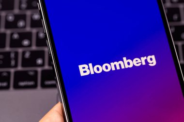 Bloomberg mobile logo app on screen smartphone iPhone in hand, macro. Bloomberg L.P. is a privately held financial software, data and media company. Moscow, Russia - July 20, 2021