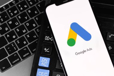 Google Ads (AdWords) logo mobile app on screen smartphone iPhone with keyboard, calculator. Google services. Google Ads is a contextual service, mainly search advertising from Google. Moscow, Russia -  July 26, 2021