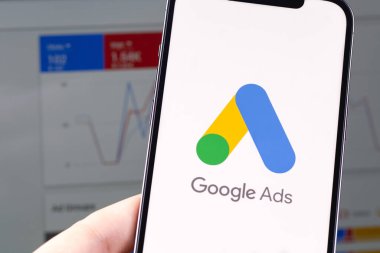 Google Ads (AdWords) logo mobile app on screen smartphone iPhone with notebook Macbook closeup. Google Ads is a contextual service, mainly search advertising from Google. Moscow, Russia -  July 22, 2021