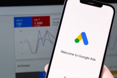 Google Ads (AdWords) logo mobile app on screen smartphone iPhone with notebook Macbook. Google Ads is a contextual service, mainly search advertising from Google. Moscow, Russia -  July 22, 2021