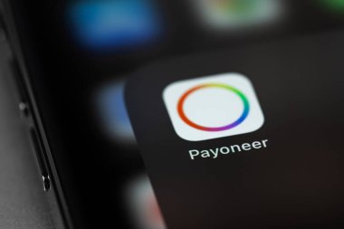 Payoneer icon mobile app on screen smartphone iPhone on grey background. Payoneer - payment system. Moscow, Russia - July 11, 2021