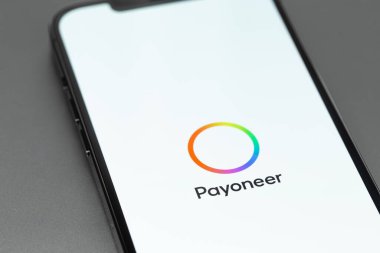 Payoneer logo mobile app on screen smartphone iPhone on grey background. Payoneer - payment system. Moscow, Russia -  July 27, 2021