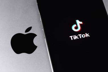 Apple logo and TikTok logo mobile app on screen smartphone iPhone closeup. TikTok is app to create and share videos. Moscow, Russia -  September 15, 2021