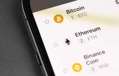 Binance coin (BNB), Ethereum, Bitcoin on screen smartphone iPhone closeup. Binance - one of the largest cryptocurrency exchange on the market. Moscow, Russia - September 20, 2021