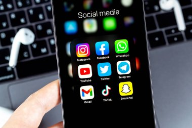 showing social media apps Instagram, Facebook, WhatsApp, YouTube, Twitter, Telegram, Gmail, TikTok, Snapchat -  on screen smartphone iPhone in hand closeup. Moscow, Russia - August 10, 2021