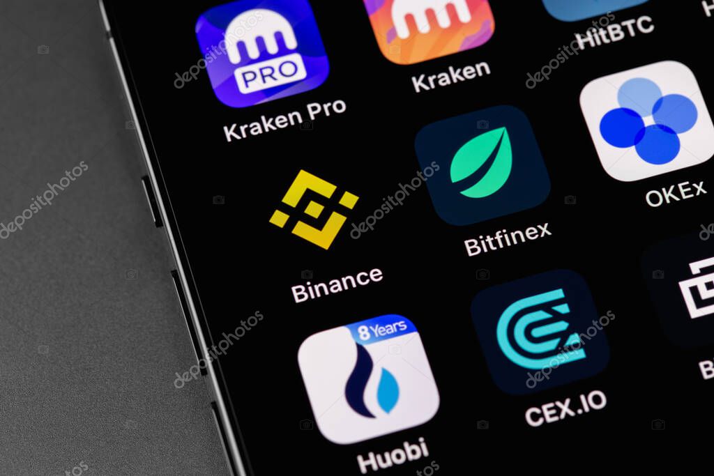 Kraken, Binance, Bitfinex, Huobi, Cex.IO, OKEx, HitBTC and other cryptocurrency exchange mobile apps on screen smartphone. Moscow, Russia - October 14, 2021
