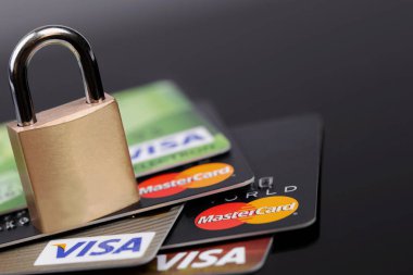 Visa and MasterCard logo on plastic electronic cards with metal lock macro. Visa and MasterCard worldwide is an American multinational financial services corporation. Moscow, Russia - February 26, 2022