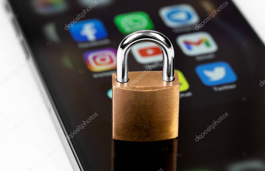 Showing blurred social media apps (YouTube. WhatsApp, Twitter, Instagram, VK and other) -  on screen smartphone iPhone with lock. Moscow, Russia - February 26, 2022