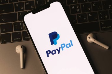 PayPal logo mobile app on screen smartphone iPhone and AirPods, Macbook. Paypal is an internet based digital money transfer service. Batumi, Georgia - March 4, 2022