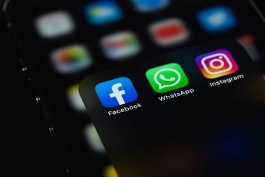 showing social media apps Facebook, WhatsApp, Instagram -  on screen smartphone iPhone in the dark. Moscow, Russia - February 26, 2022
