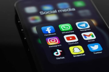 showing social media apps YouTube, WhatsApp, Twitter, Instagram, and other -  on screen smartphone iPhone in the dark. Moscow, Russia - February 26, 2022