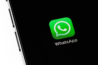 WhatsApp mobile icon app on screen smartphone iPhone closeup. WhatsApp is a popular free instant text messaging system for mobile and other platforms. Batumi, Georgia - March 3, 2022