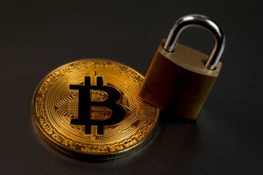 bitcoin cryptocurrency with metal lock in the dark closeup