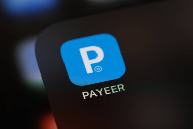 Payeer mobile app on the screen smartphone iPhone. Payeer is a web wallet designed to work with digital currencies and fiat currencies. Batumi, Georgia - March 7, 2022