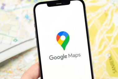 Google Maps icon app on the screen smartphone on blurred maps background. Google Maps is a set of applications built on a free map service and technology. Moscow, Russia - October 17, 2021