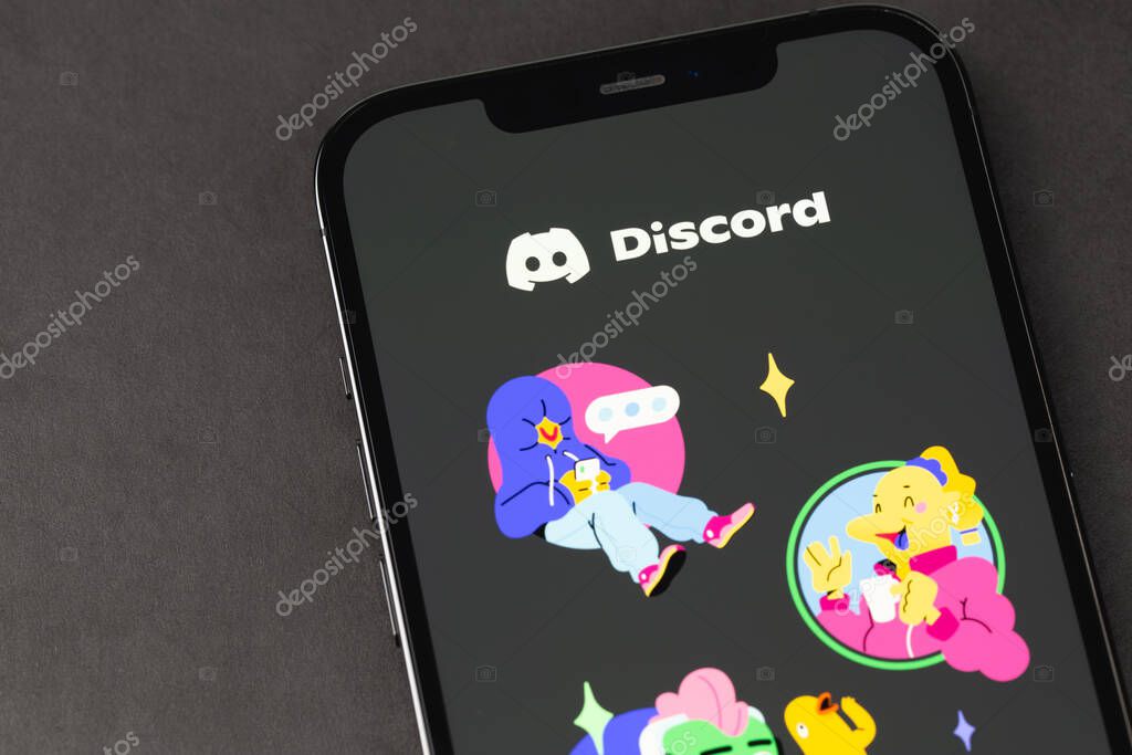 Discord mobile app on the screen iPhone smartphone closeup. Discord is a cross-platform proprietary instant messaging system with support for VoIP and video conferencing. Batumi, Georgia - May 7, 2022