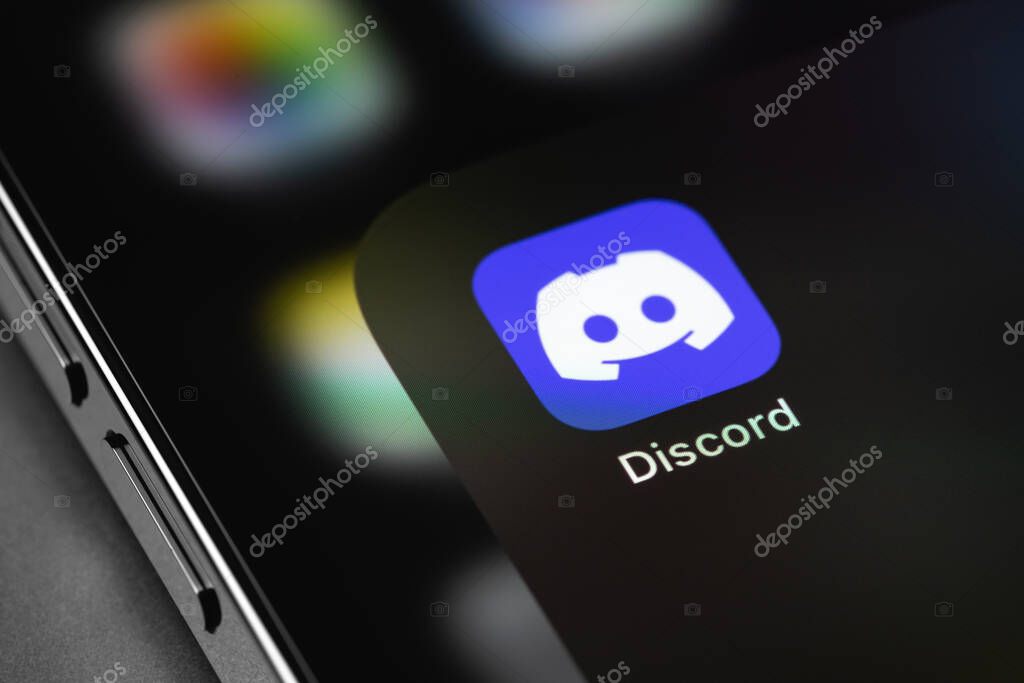 Discord mobile icon app on the screen iPhone smartphone macro. Discord is a cross-platform proprietary instant messaging system with support for VoIP and video conferencing. Batumi, Georgia - May 7, 2022
