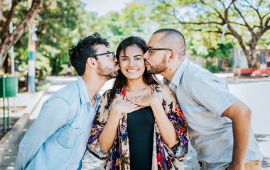 Two men kissing a girl cheek. Portrait of two guys kissing a girl cheek. Two young men kissing a woman cheek outdoor, love triangle concept. Polygamy concept clipart