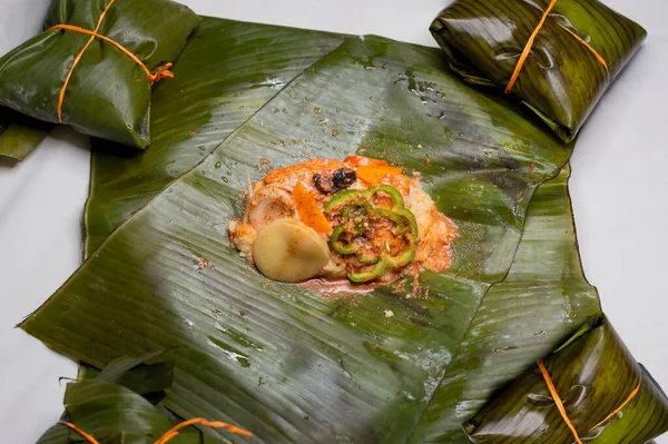 Top View of raw ingredients of the Nicaraguan nacatamal on banana leaves. Raw ingredients for the preparation of the traditional Nacatamal, Nacatamal ingredients on banana leaves