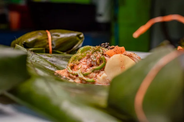 Closeup of raw ingredients for the elaboration of a Nicaraguan nacatamal. Nacatamal ingredients on banana leaves, Preparation of the traditional Nacatamal